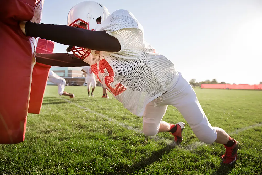 The 3 most common football shoulder injuries (and how to deal with them) american football player pushing football sled on 2022 05 26 01 28 18 utc The 3 most common football shoulder injuries (and how to deal with them)