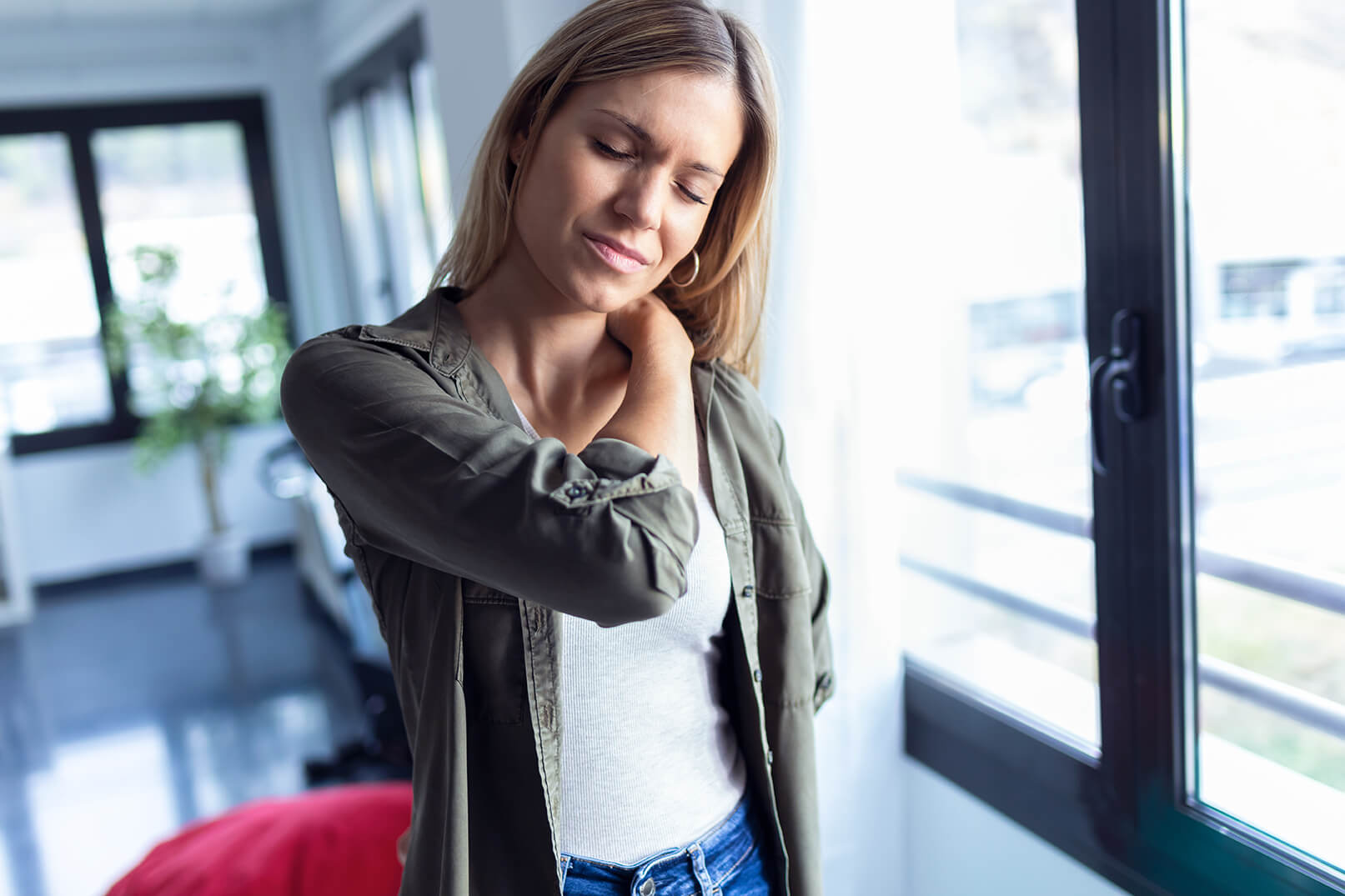 3 ways to treat scoliosis-related neck pain with physical therapy tired young woman with neck and back pain standing 2022 12 15 18 11 30 utc 3 ways to treat scoliosis-related neck pain with physical therapy