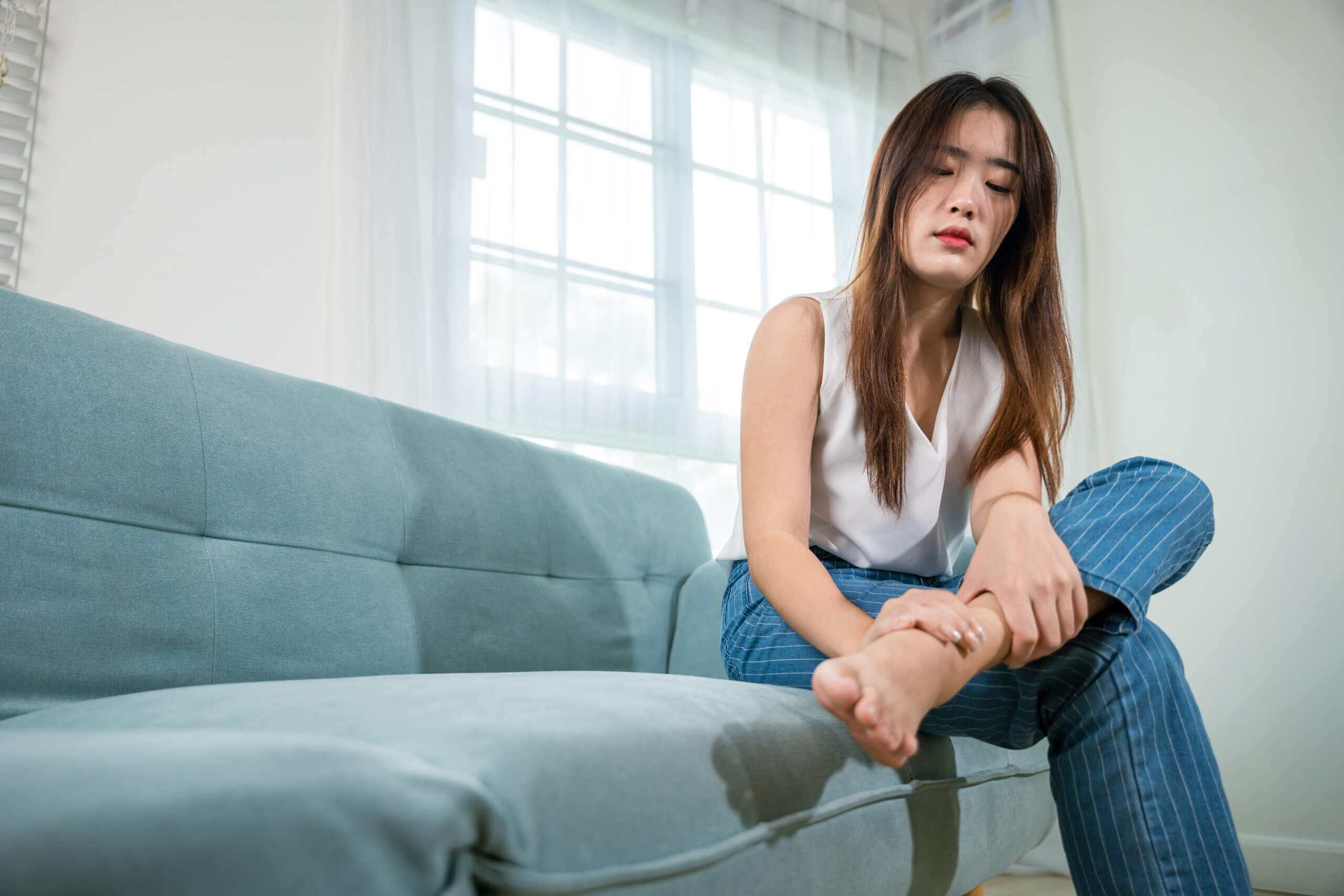 4 issues that can cause stabbing pain in the side of your foot asian beautiful female problems with foot at home 2023 10 09 21 03 17 utc scaled 1 4 issues that can cause stabbing pain in the side of your foot
